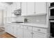 Modern kitchen with sleek white cabinets, stainless steel appliances, and stylish backsplash at 137 Brawley Woods Ln, Mooresville, NC 28115