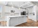 Bright kitchen featuring white cabinetry, a large center island, stainless steel appliances, and hardwood flooring at 137 Brawley Woods Ln, Mooresville, NC 28115