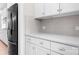 Bright kitchen featuring stainless steel fridge, white cabinets, and gray subway tile backsplash at 137 Brawley Woods Ln, Mooresville, NC 28115