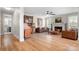 Inviting living room with fireplace, light hardwood floors, ceiling fan, and comfortable seating at 137 Brawley Woods Ln, Mooresville, NC 28115