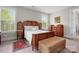 Bright main bedroom with large windows, beautiful rug and traditional furnishings at 137 Brawley Woods Ln, Mooresville, NC 28115