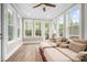 Bright sunroom with large windows, and cozy seating at 137 Brawley Woods Ln, Mooresville, NC 28115