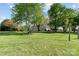 A lush green yard surrounds the home, showcasing a serene and spacious outdoor environment at 14855 Nc 801 Hwy Hwy, Mt Ulla, NC 28125