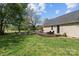 Spacious backyard with wooden deck, outdoor seating, and lush green lawn at 14855 Nc 801 Hwy Hwy, Mt Ulla, NC 28125