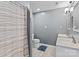 Bathroom features double sinks, tile floors, and bathtub with neutral-colored shower curtain at 14855 Nc 801 Hwy Hwy, Mt Ulla, NC 28125