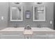 Modern bathroom with double vanity, white cabinets, and decorative mirrors at 14855 Nc 801 Hwy Hwy, Mt Ulla, NC 28125