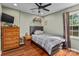 Comfortable bedroom with dark bed frame, hardwood floors, and window at 14855 Nc 801 Hwy Hwy, Mt Ulla, NC 28125
