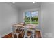 Cozy dining area with natural light, wood floors, and views of the landscaped backyard at 14855 Nc 801 Hwy Hwy, Mt Ulla, NC 28125
