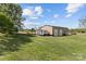Spacious outbuilding on a vast, grassy lawn, offering practical storage and workspace alongside a camper at 14855 Nc 801 Hwy Hwy, Mt Ulla, NC 28125