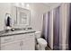 Neutral bathroom featuring granite vanity and a shower with a modern curtain at 1501 Riverwalk Pkwy, Rock Hill, SC 29730