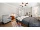 A bedroom featuring hardwood floors, two chairs, and a comfortable bed at 1501 Riverwalk Pkwy, Rock Hill, SC 29730