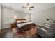 A bedroom featuring a ceiling fan, bedside lamps, and hardwood floors at 1501 Riverwalk Pkwy, Rock Hill, SC 29730