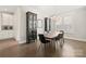 A dining room with modern decor and hardwood floors adjacent to a kitchen area at 1501 Riverwalk Pkwy, Rock Hill, SC 29730