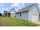 Exterior view of a home with a well-kept lawn, a detached garage, and neat landscaping at 1501 Riverwalk Pkwy, Rock Hill, SC 29730