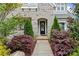 Charming entrance with an arched doorway and a walkway flanked by landscaped bushes at 1501 Riverwalk Pkwy, Rock Hill, SC 29730