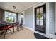 Cozy front porch features a table and chairs with a black front door and seasonal wreath at 1501 Riverwalk Pkwy, Rock Hill, SC 29730