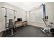 Bright home gym with rubber floor, workout equipment and natural light from plantation shutters at 1501 Riverwalk Pkwy, Rock Hill, SC 29730
