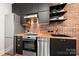 Modern kitchen design with stainless steel appliances and exposed brick backsplash at 1501 Riverwalk Pkwy, Rock Hill, SC 29730