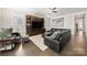 Open living area with a plush sectional, modern entertainment center, and bright natural light at 1501 Riverwalk Pkwy, Rock Hill, SC 29730