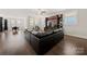 Spacious living room features hardwood floors, a dark sectional sofa, and a built-in entertainment center at 1501 Riverwalk Pkwy, Rock Hill, SC 29730