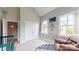 Bright Bedroom featuring windows, a glider chair, colorful decor, and a tall ceiling at 1511 Landis Ave, Charlotte, NC 28205