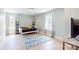 Bright bedroom with light hardwood floors, light blue walls, a bed, and a patterned blue rug at 1511 Landis Ave, Charlotte, NC 28205