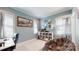 Cozy bedroom with a comfortable reading chair, shelving, and natural light from the windows at 1511 Landis Ave, Charlotte, NC 28205