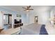 Bright main bedroom features light blue and white walls, a ceiling fan, a gray bed, and a main bathroom at 1511 Landis Ave, Charlotte, NC 28205