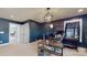 Office with dark blue walls, a large desk, a decorative light fixture, and two doorways at 1511 Landis Ave, Charlotte, NC 28205