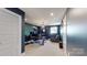 Office with dark blue walls, a large desk, a decorative light fixture, and an accent chair at 1511 Landis Ave, Charlotte, NC 28205