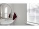 Charming powder room featuring a pedestal sink and decorative mirror at 15127 Oleander Dr, Charlotte, NC 28278