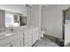 Bathroom with double vanity, framed mirrors, and a separate shower and toilet area at 15127 Oleander Dr, Charlotte, NC 28278