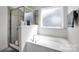 Bathroom with a soaking tub, shower, and a frosted glass window for natural light and privacy at 15127 Oleander Dr, Charlotte, NC 28278