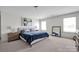 Bright bedroom features a large bed with side tables and decorative art on the wall at 15127 Oleander Dr, Charlotte, NC 28278