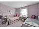 Cozy bedroom with two beds, soft pink walls, and a window with sheer curtains at 15127 Oleander Dr, Charlotte, NC 28278