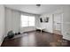Bright bonus room with hardwood floors, a window, and a laundry room in the background at 15127 Oleander Dr, Charlotte, NC 28278
