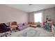 Bonus room with a sectional sofa, an area rug, and a doll house at 15127 Oleander Dr, Charlotte, NC 28278