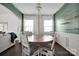 Elegant dining room with modern chandelier, wainscoting, and bright windows with curtains at 15127 Oleander Dr, Charlotte, NC 28278