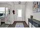 Bright entryway with hardwood floors, an elegant light fixture, and a view into the office space at 15127 Oleander Dr, Charlotte, NC 28278