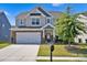 Charming two-story home with a manicured lawn, a two-car garage, and stylish exterior features at 15127 Oleander Dr, Charlotte, NC 28278