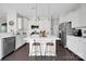 Modern kitchen with white cabinetry, stainless steel appliances, and a center island with seating at 15127 Oleander Dr, Charlotte, NC 28278