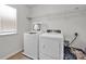 Functional laundry room with a washer, dryer, and ample shelving for storage at 15127 Oleander Dr, Charlotte, NC 28278
