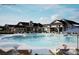 Resort-style pool and patio area complete with lounge chairs, blue skies, and large shade umbrellas at 1619 Shoals Ave # 156, Belmont, NC 28012