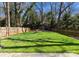 Expansive green backyard enclosed by a wooden fence, providing privacy and space for outdoor activities at 1751 Merriman Ave, Charlotte, NC 28203