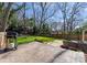 Paver patio with built-in grill, grassy area, and lovely landscaping in a fenced backyard at 1751 Merriman Ave, Charlotte, NC 28203