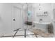 Bright and airy bathroom with a luxurious soaking tub and a separate glass-enclosed shower, perfect for relaxation at 1751 Merriman Ave, Charlotte, NC 28203