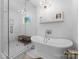 Bright and airy bathroom with a luxurious soaking tub and a separate glass-enclosed shower, perfect for relaxation at 1751 Merriman Ave, Charlotte, NC 28203