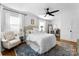 Bright primary bedroom with large windows, plush carpet, and a cozy bed, plus a view to a home office at 1751 Merriman Ave, Charlotte, NC 28203