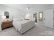 Cozy bedroom featuring neutral walls, soft carpet, walk-in closet, and ample light with large windows at 1751 Merriman Ave, Charlotte, NC 28203