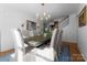 Elegant dining room with chandelier, seating for eight, and view of the staircase, perfect for entertaining at 1751 Merriman Ave, Charlotte, NC 28203